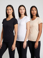Three women modeling short-sleeve crew-neck t-shirts in black, white, and light beige, paired with black leggings, against a light gray studio background.