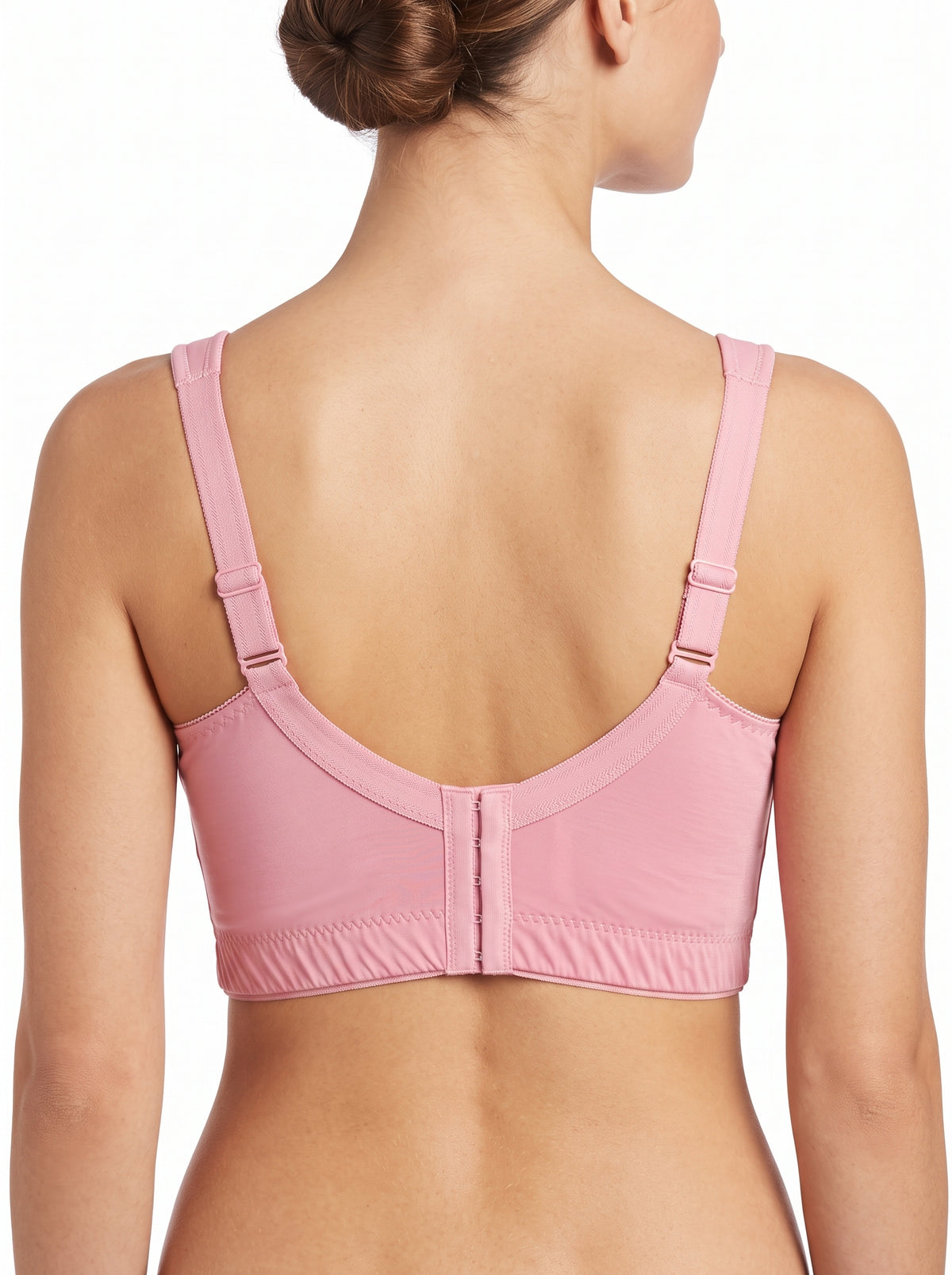 A woman shown from the back wearing a light pink bra with adjustable shoulder straps and a center gore closure, photographed against a plain white background.